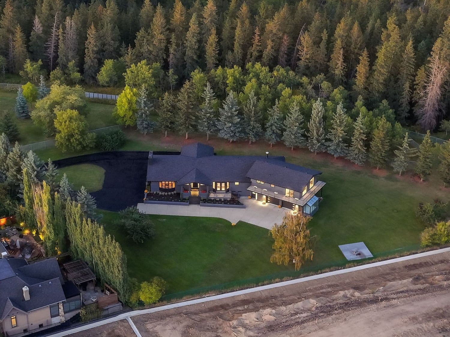 Aerial view of the home and its treed 1.07-acre lot