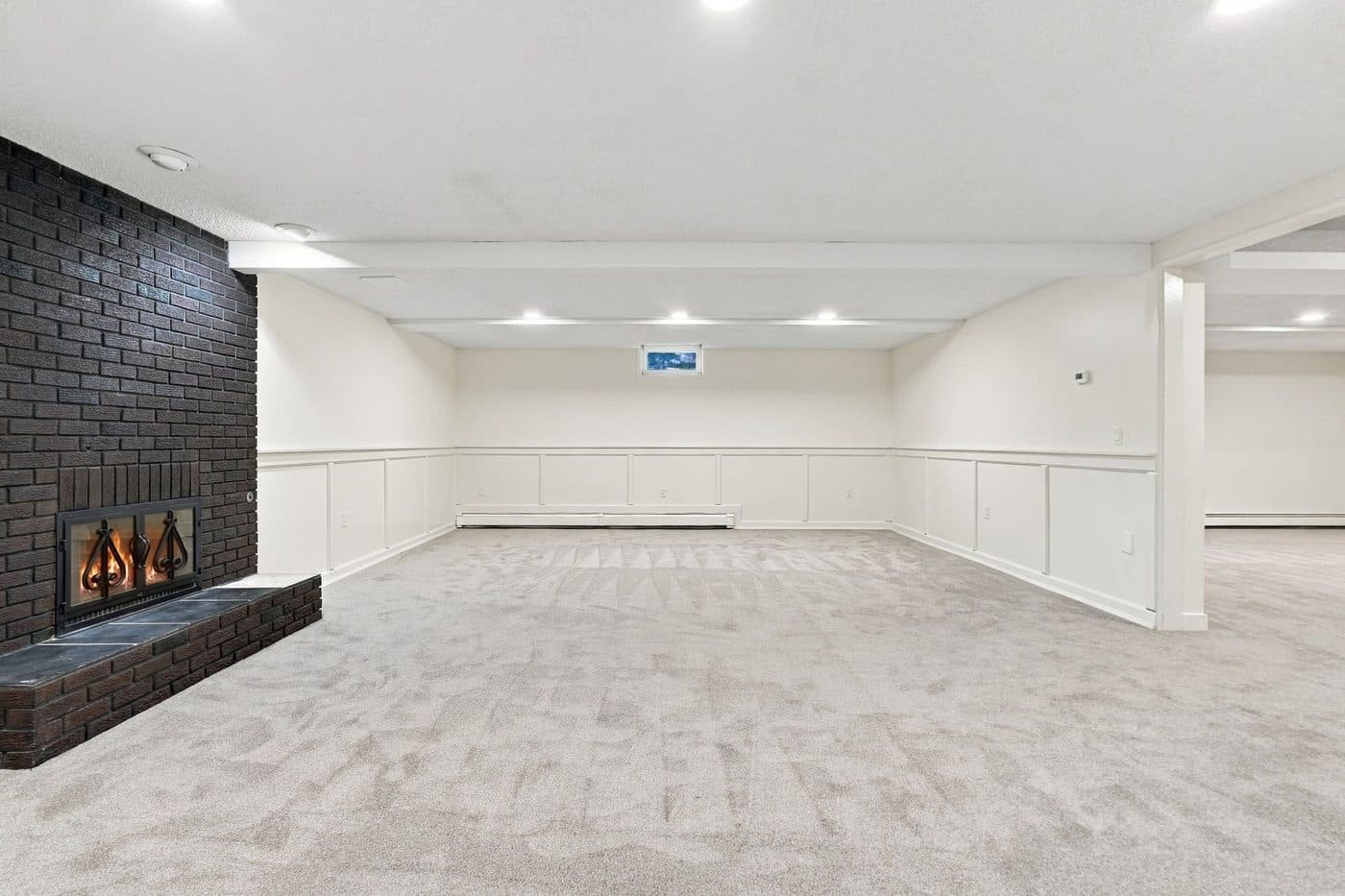 Finished lower-level recreation room with fireplace
